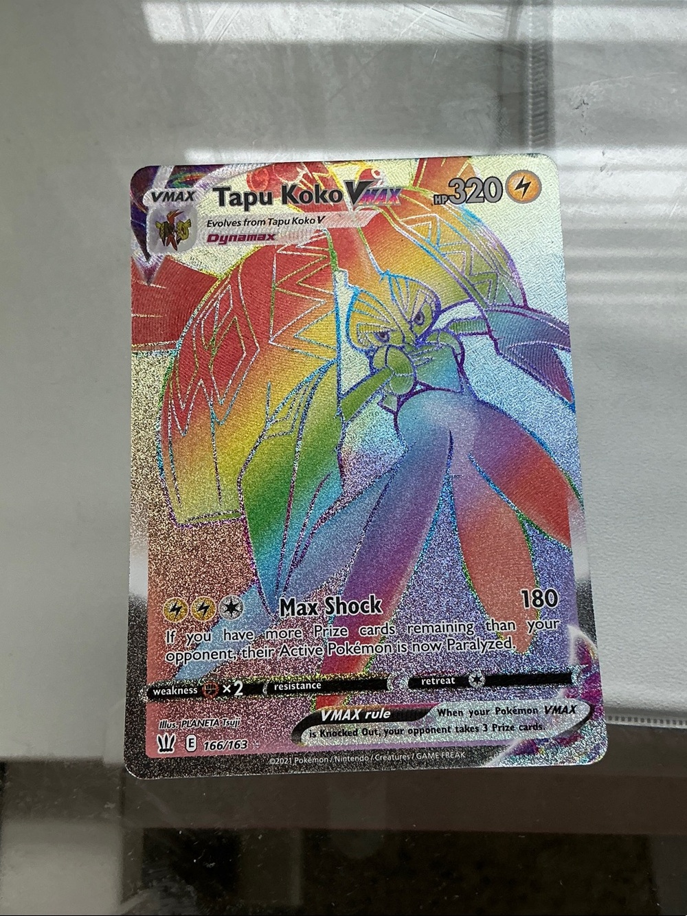 Tapu Koko VMAX Rainbow Holo Pokémon Card - Yellow/Gold/Red/Blue/Purple